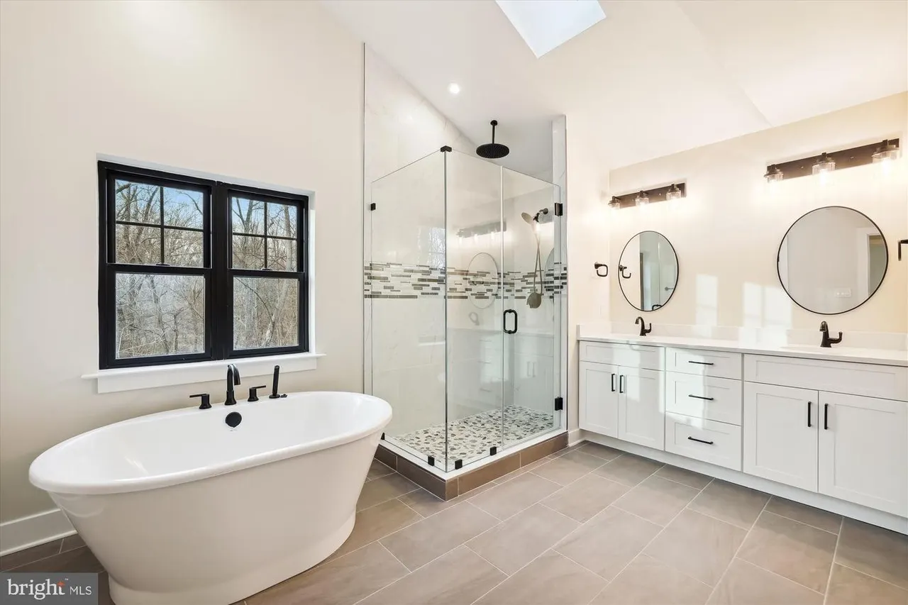 Luxury primary bath with freestanding tub and large walk-in shower
