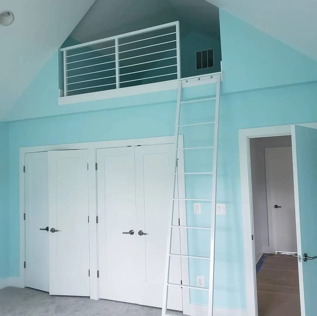 Bedroom with vaulted ceiling, loft, white ladder, and double closets